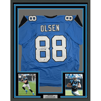 Framed Autographed/Signed Greg Olsen 35x39 Carolina Blue Football Jersey Beckett BAS COA