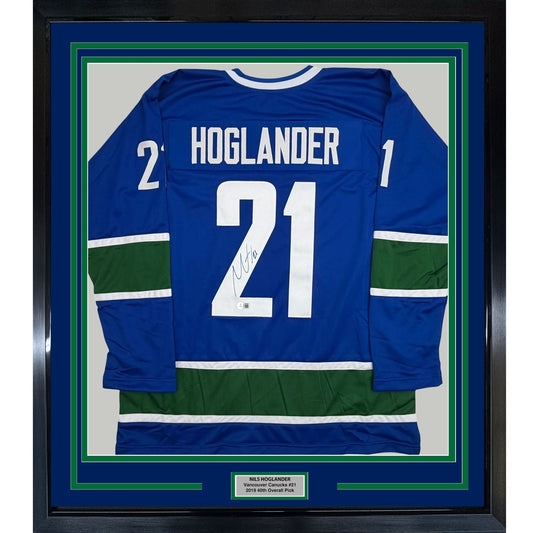 Framed Autographed/Signed Nils Hoglander 35x39 Vancouver Blue Hockey Jersey Beckett BAS COA