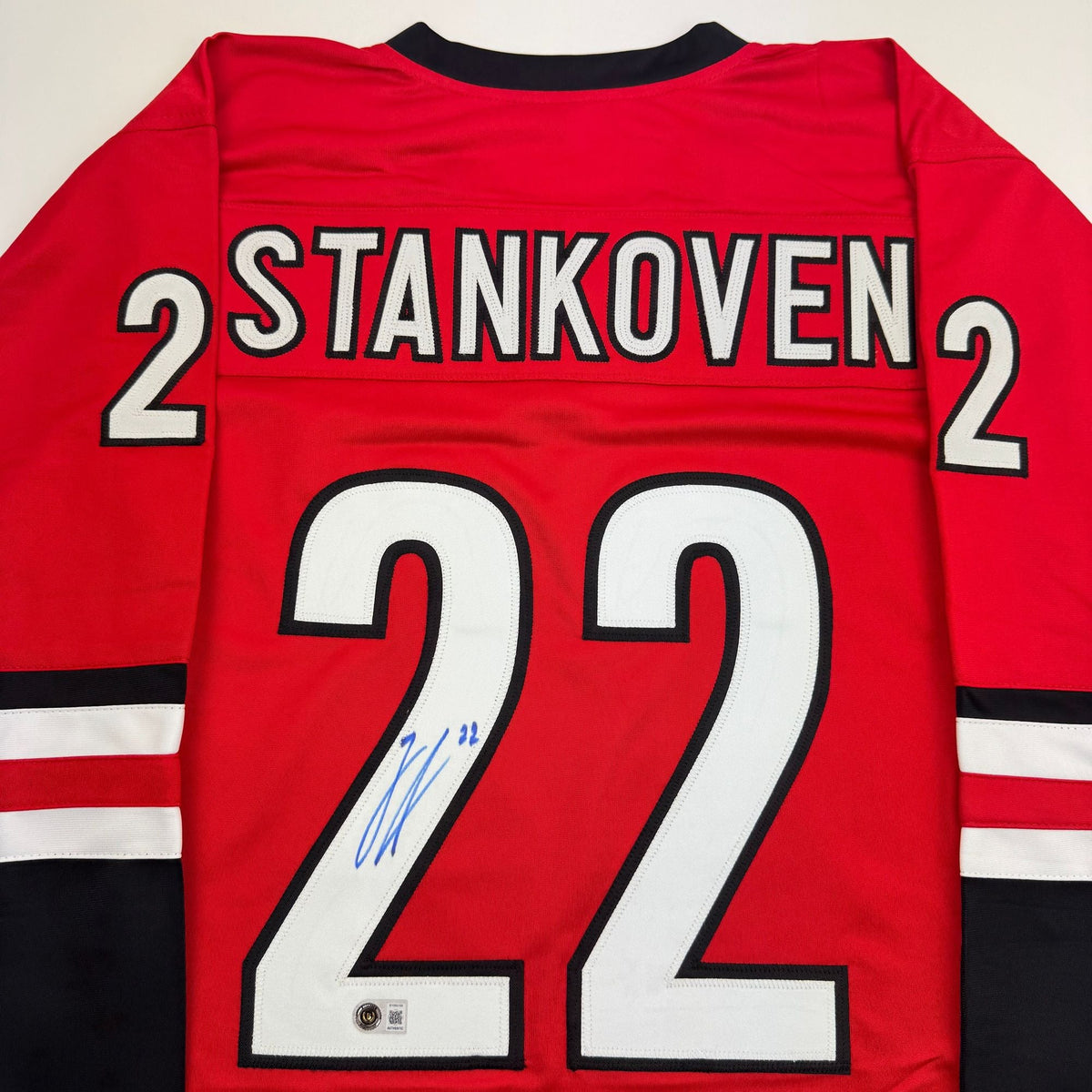 Autographed/Signed Logan Stankoven Carolina Red Hockey Jersey Beckett BAS COA