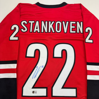 Autographed/Signed Logan Stankoven Carolina Red Hockey Jersey Beckett BAS COA