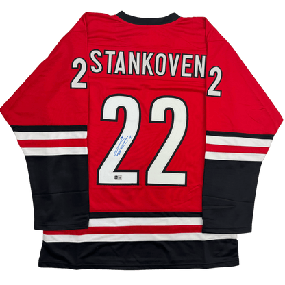 Autographed/Signed Logan Stankoven Carolina Red Hockey Jersey Beckett BAS COA
