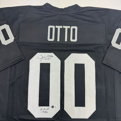 Autographed/Signed Jim Otto w/ HOF 1980 Oakland Black Football Jersey Beckett BAS COA