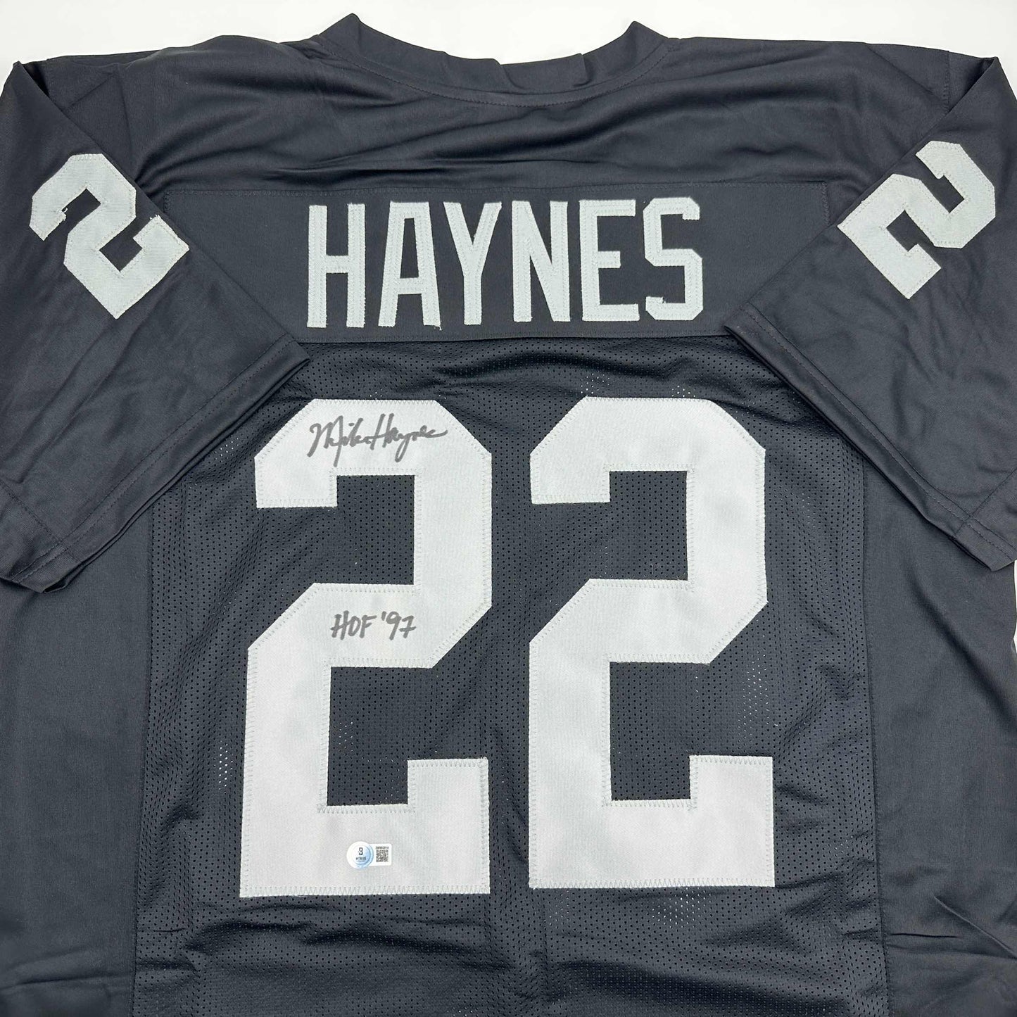 Autographed/Signed Michael Mike Haynes HOF 97 Oakland Black Football Jersey Beckett BAS COA