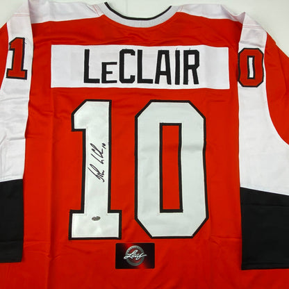 Autographed/Signed John LeClair Philadelphia Orange Hockey Jersey Leaf Authentics COA