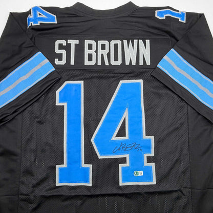 Autographed/Signed Amon-Ra St. Brown Detroit Black Football Jersey Beckett BAS COA