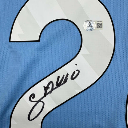 Autographed/Signed Savinho Manchester City Blue Soccer Futbol Jersey Beckett BAS COA