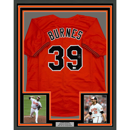 Framed Autographed/Signed Corbin Burnes 35x39 Baltimore Orange Baseball Jersey Beckett BAS COA
