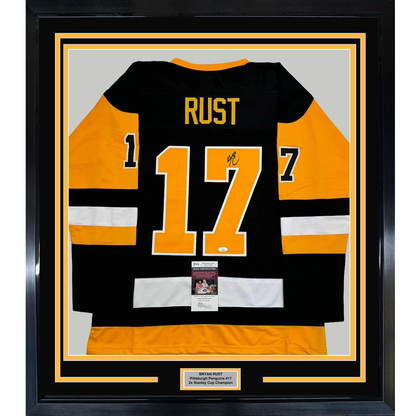 Framed Autographed/Signed Bryan Rust 35x39 Pittsburgh Black Hockey Jersey JSA COA
