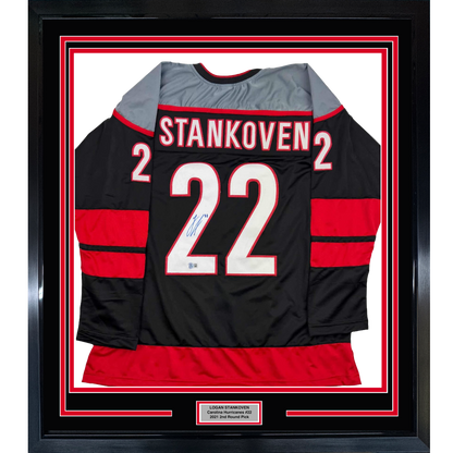 Framed Autographed/Signed Logan Stankoven 35x39 Carolina Black Hockey Jersey Beckett BAS COA