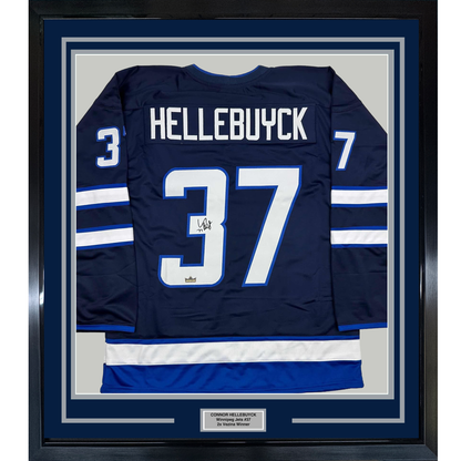 Framed Facsimile Autographed Connor Hellebuyck 35x39 Winnipeg Blue Reprint Laser Auto Hockey Jersey