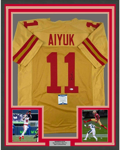 Framed Autographed/Signed Brandon Aiyuk 35x39 San Francisco Gold Football Jersey Beckett BAS COA
