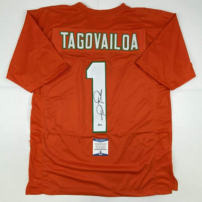 Autographed/Signed Tua Tagovailoa Miami Orange Football Jersey Beckett BAS COA