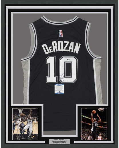Framed Autographed/Signed DeMar DeRozan 35x39 San Antonio Black Basketball Jersey Beckett BAS COA